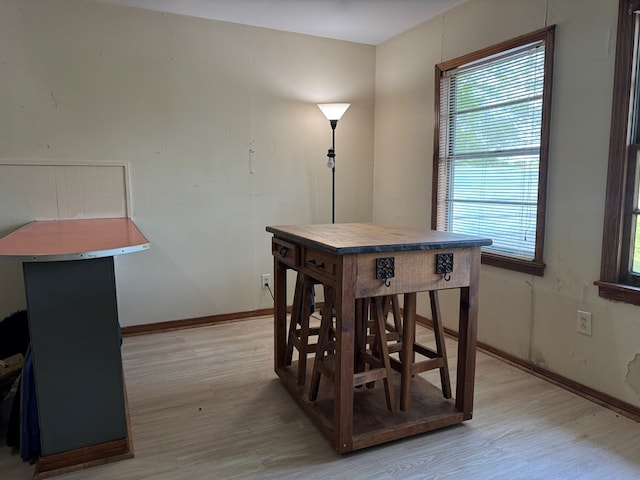 dining room with baseboards and light wood-style floors