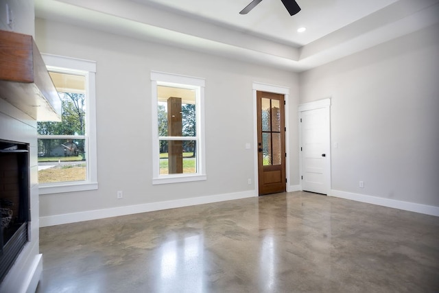 interior space featuring ceiling fan and concrete floors