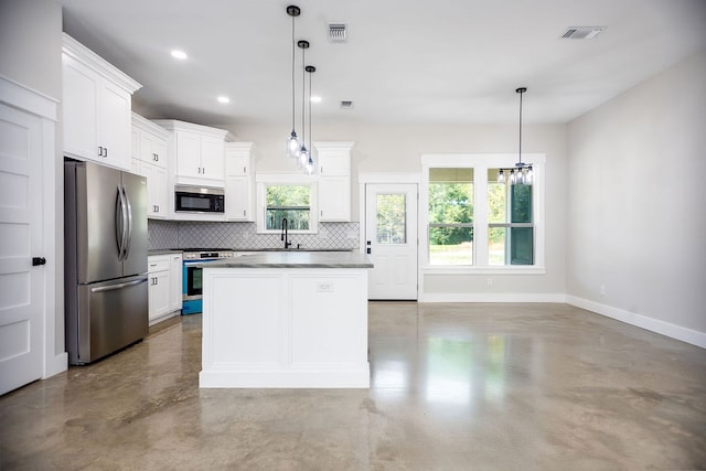 kitchen featuring pendant lighting, a center island, white cabinetry, and stainless steel appliances