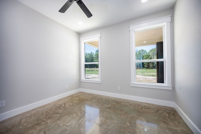 unfurnished room featuring ceiling fan and a wealth of natural light