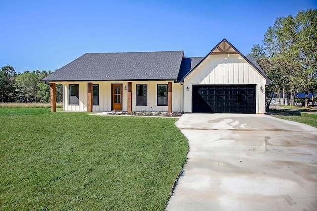 modern farmhouse featuring a porch, a garage, and a front yard