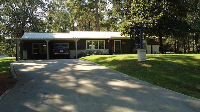 ranch-style house featuring a carport and a front yard