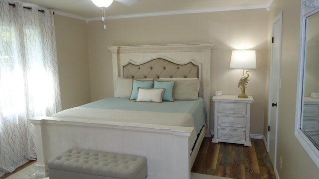 bedroom with crown molding, ceiling fan, and dark hardwood / wood-style floors