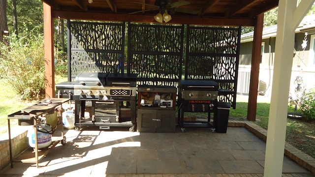 view of patio with grilling area, ceiling fan, and exterior kitchen