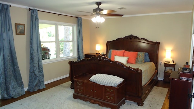 bedroom with ceiling fan, light wood-type flooring, and crown molding