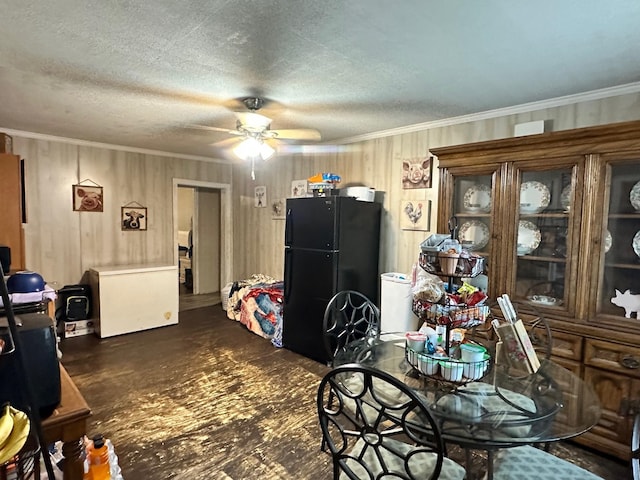 dining room with a textured ceiling, crown molding, ceiling fan, and dark hardwood / wood-style floors