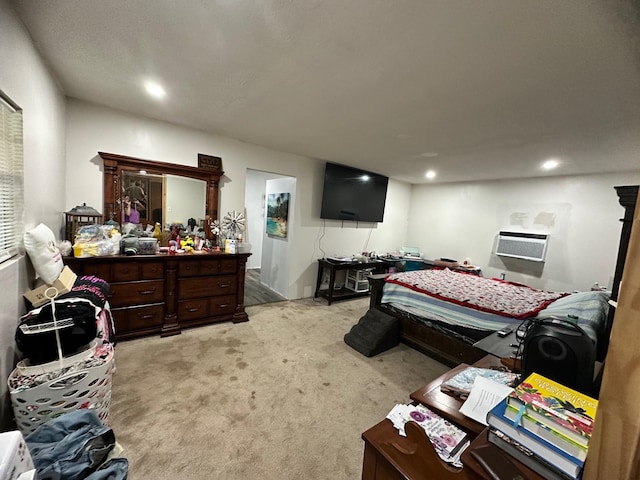 bedroom with a wall mounted AC and light carpet