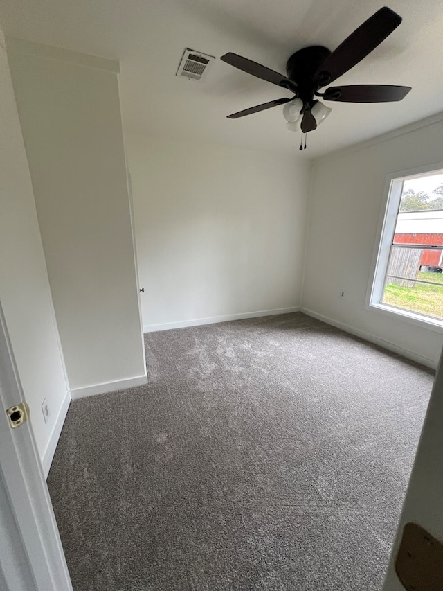 unfurnished room with visible vents, carpet floors, and baseboards