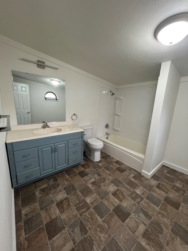 bathroom featuring toilet, shower / bathtub combination, a textured ceiling, baseboards, and vanity