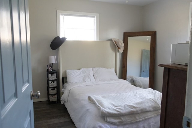 bedroom with dark wood-style floors