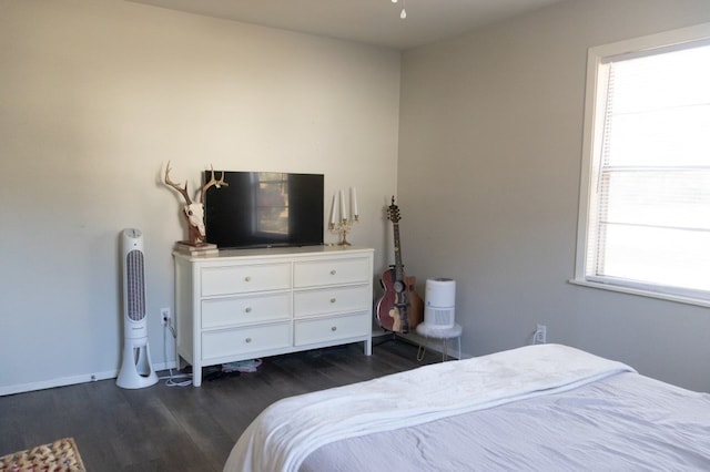 bedroom featuring dark wood-type flooring and baseboards