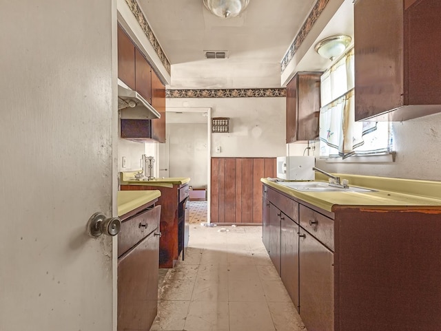 3314 Brook Holw, Nacogdoches, TX 75964 - kitchen featuring wainscoting, under cabinet range hood, and white microwave
