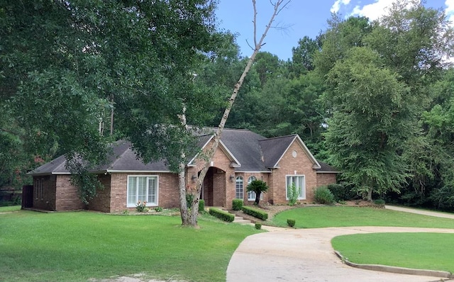 810 Denton Dr, Jasper, TX 75951 - view of front of house featuring brick siding, a front lawn, and a shingled roof