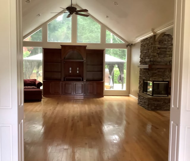 810 Denton Dr, Jasper, TX 75951 - living room with ceiling fan, a stone fireplace, light wood-type flooring, and high vaulted ceiling