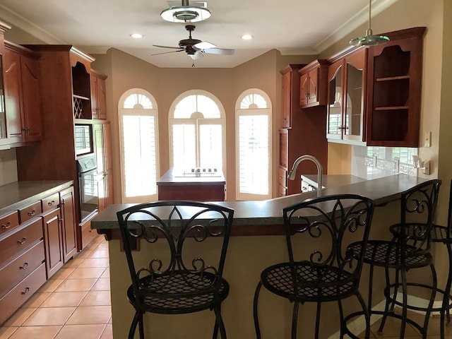 810 Denton Dr, Jasper, TX 75951 - kitchen with stainless steel oven, ceiling fan, open shelves, a peninsula, and a kitchen breakfast bar