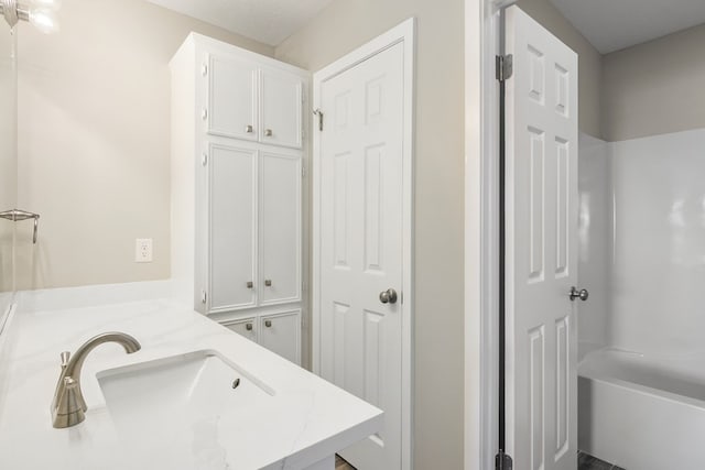 full bathroom with vanity and bathing tub / shower combination