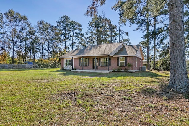 single story home with central AC, a front lawn, fence, and brick siding