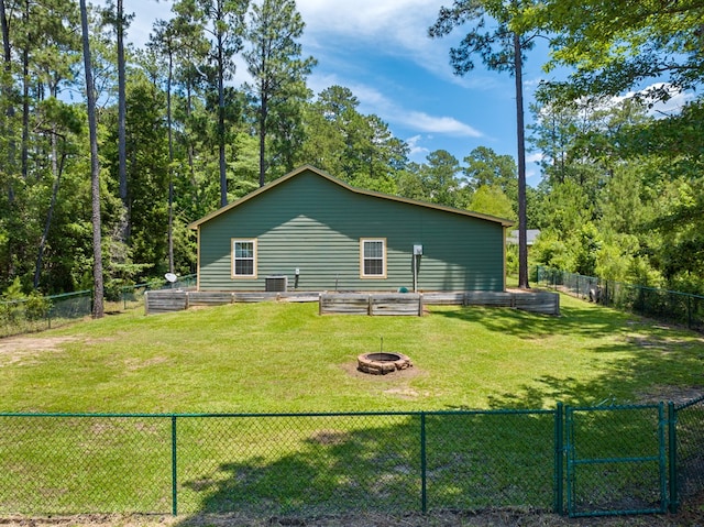 182 Post Oak Ln, Brookeland, TX 75931 - back of property with an outdoor fire pit, a garden, and a gate