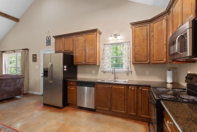 182 Post Oak Ln, Brookeland, TX 75931 - kitchen with appliances with stainless steel finishes, a sink, healthy amount of natural light, brown cabinetry, and high vaulted ceiling
