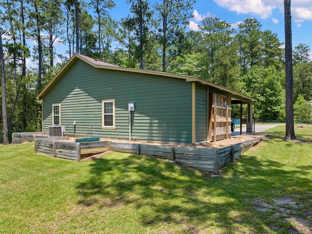 182 Post Oak Ln, Brookeland, TX 75931 - view of side of home with a yard and a vegetable garden