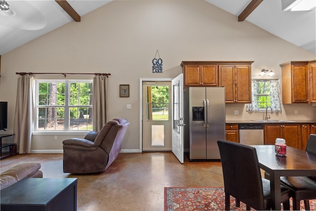 182 Post Oak Ln, Brookeland, TX 75931 - kitchen featuring stainless steel appliances, high vaulted ceiling, a sink, open floor plan, and brown cabinetry
