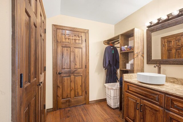 388 County Road 5597, Etoile, TX 75944 - bathroom featuring wood finished floors, vanity, and baseboards