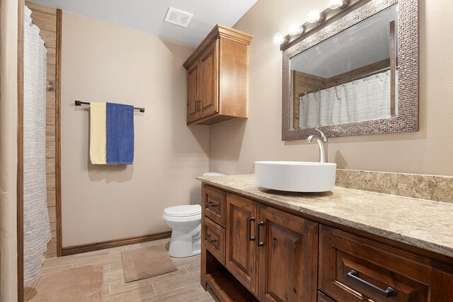 388 County Road 5597, Etoile, TX 75944 - full bathroom with toilet, vanity, baseboards, and a shower with shower curtain