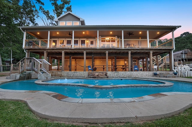 388 County Road 5597, Etoile, TX 75944 - back of property with stairway, a ceiling fan, a hot tub, and a patio area