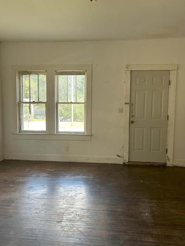 unfurnished room featuring dark wood-type flooring