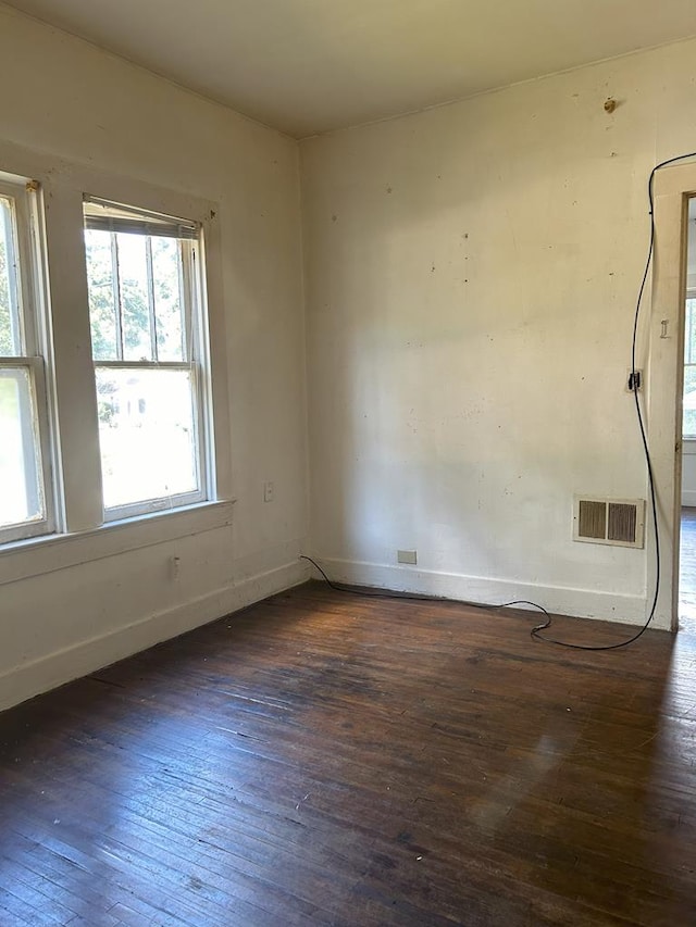 spare room with dark hardwood / wood-style floors