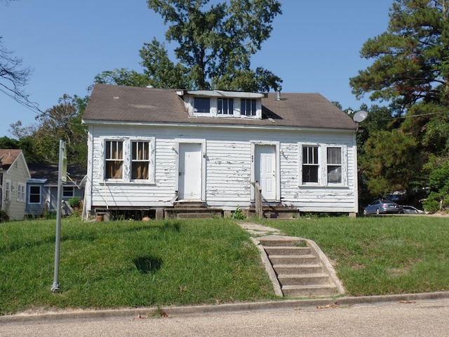 bungalow-style home with a front yard