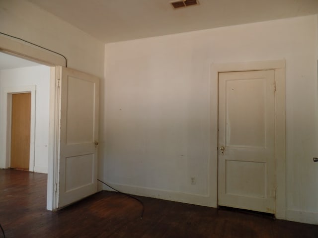 empty room featuring dark wood-type flooring