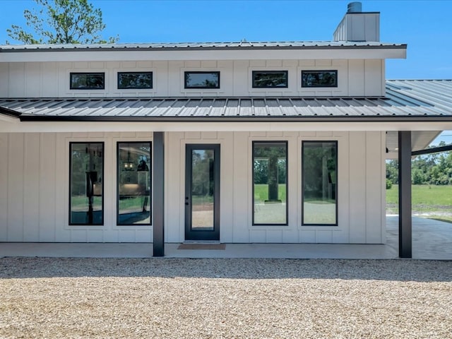 10165 US Highway 287, Corrigan, TX 75939 - rear view of house featuring a chimney and a metal roof