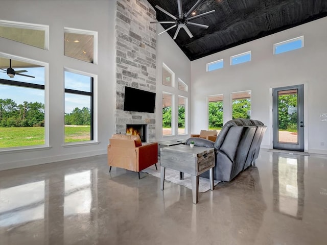10165 US Highway 287, Corrigan, TX 75939 - living area with high vaulted ceiling, ceiling fan, concrete flooring, and a stone fireplace