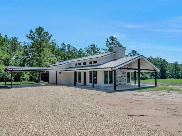 10165 US Highway 287, Corrigan, TX 75939 - view of front facade featuring a carport, driveway, and a metal roof