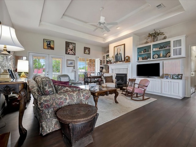 325 Evans Gann Rd, Lufkin, TX 75904 - living area with a raised ceiling, french doors, dark wood-style floors, ceiling fan, and a tile fireplace