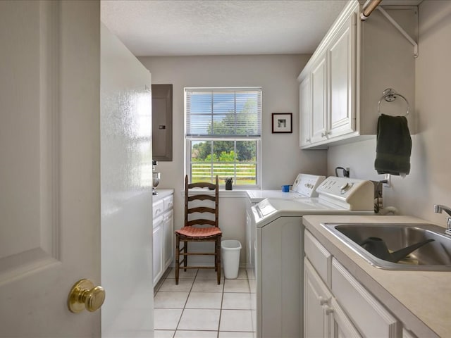 325 Evans Gann Rd, Lufkin, TX 75904 - laundry area featuring cabinet space, washer and clothes dryer, electric panel, and light tile patterned floors