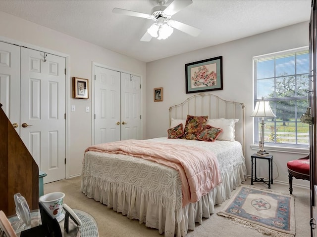 325 Evans Gann Rd, Lufkin, TX 75904 - bedroom with light carpet, multiple closets, and a ceiling fan