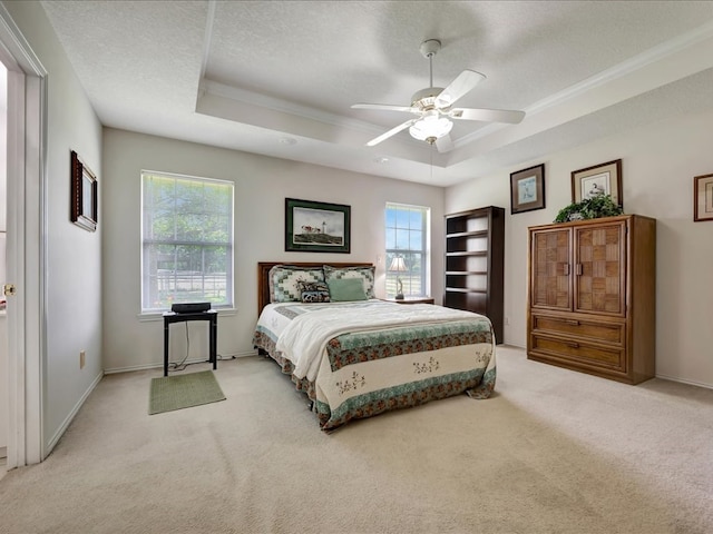 325 Evans Gann Rd, Lufkin, TX 75904 - bedroom featuring a raised ceiling, multiple windows, light colored carpet, crown molding, and ceiling fan