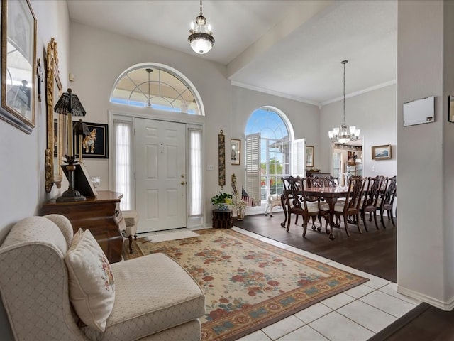 325 Evans Gann Rd, Lufkin, TX 75904 - foyer with a chandelier, a towering ceiling, crown molding, and tile patterned flooring