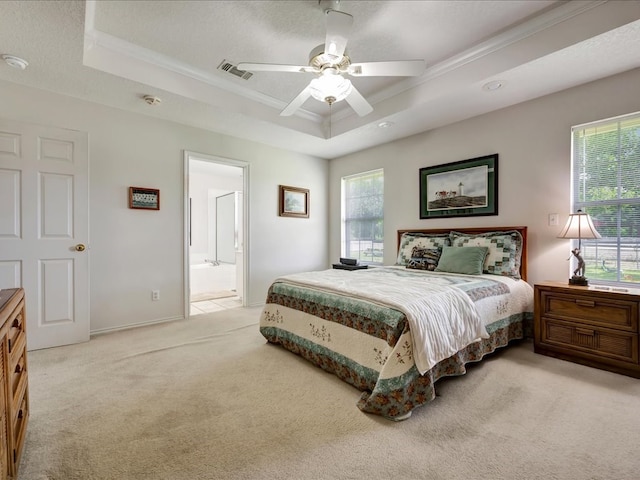 325 Evans Gann Rd, Lufkin, TX 75904 - bedroom featuring a tray ceiling, light colored carpet, crown molding, a ceiling fan, and ensuite bath