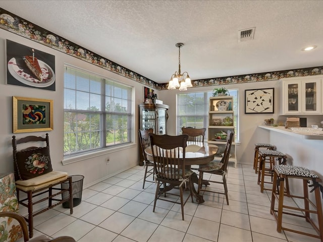 325 Evans Gann Rd, Lufkin, TX 75904 - dining space featuring a chandelier, a textured ceiling, and light tile patterned floors
