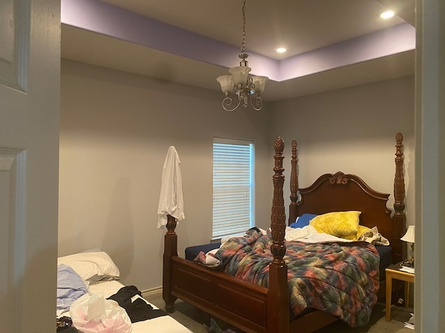 bedroom with carpet floors and a notable chandelier