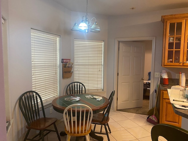 dining space with a chandelier and light tile patterned floors