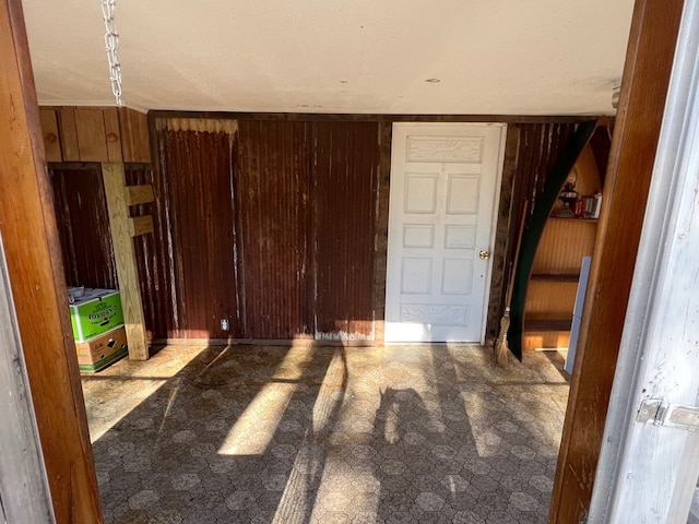 bedroom featuring wood walls