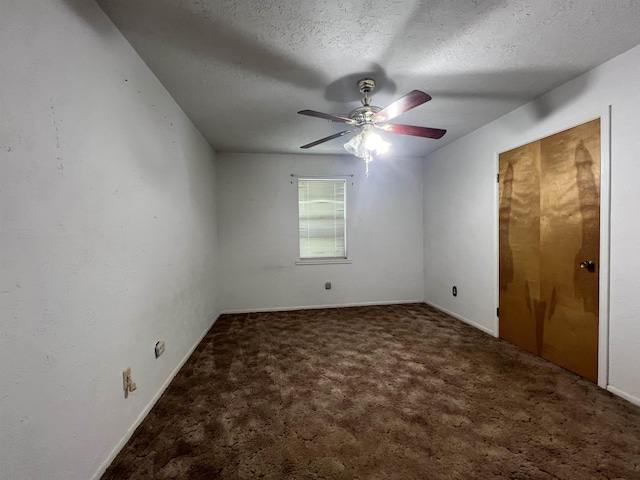 spare room featuring ceiling fan, carpet floors, and a textured ceiling