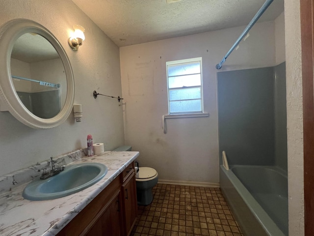 bathroom with tile patterned floors, vanity, a textured ceiling, and toilet