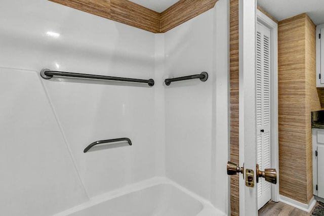 bathroom featuring hardwood / wood-style floors and shower / bathing tub combination