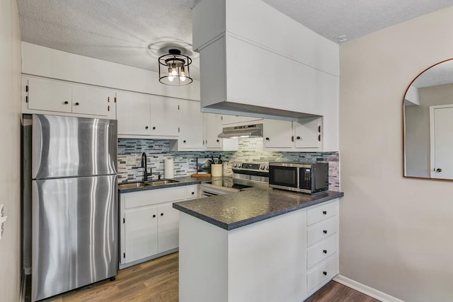 kitchen featuring a textured ceiling, appliances with stainless steel finishes, white cabinets, and sink