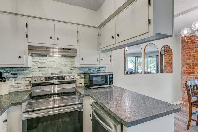 kitchen featuring white cabinets, backsplash, stainless steel appliances, and light hardwood / wood-style floors